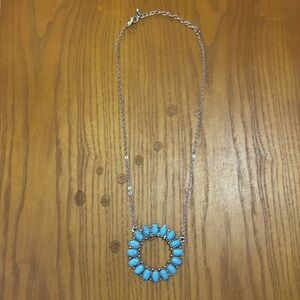 Circular charm on necklace